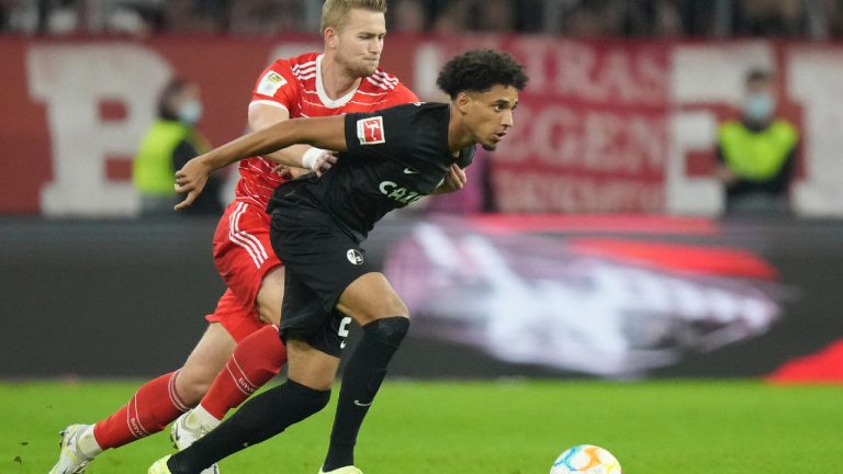 Freiburg's Kevin Schade, right, challenges for the ball with Bayern's Matthijs de Ligt during the German Bundesliga soccer match between FC Bayern Munich and SC Freiburg at the Allianz Arena in Munich, Germany, Oct. 16, 2022. (Matthias Schrader/AP)