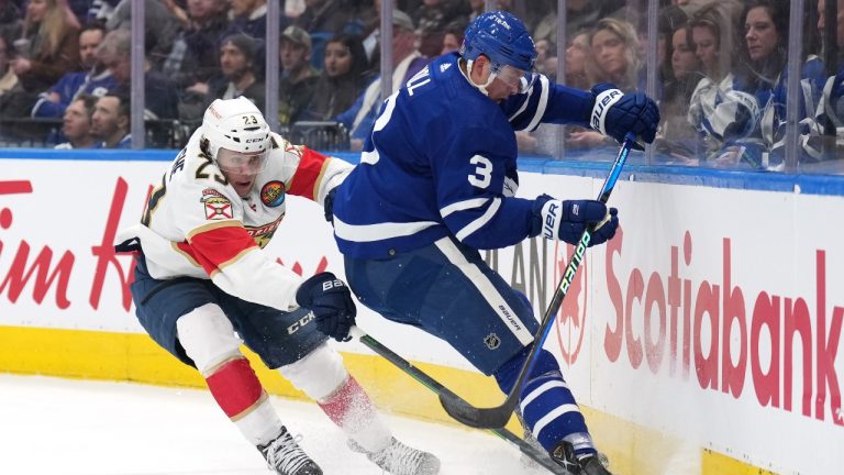 Florida Panthers forward Carter Verhaeghe (23) and Toronto Maple Leafs defenceman Justin Holl (3) battle for the puck during first period NHL hockey action in Toronto on Tuesday, January 17, 2023. (Nathan Denette/CP)