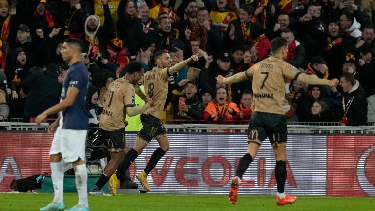 Lens' Alexis Claude-Maurice, centre, celebrates after scoring his side's third goal during the French League One soccer match between Lens and Paris Saint-Germain at the Bollaert stadium in Lens, France Sunday, Jan. 1, 2023 (Thibault Camus/AP)