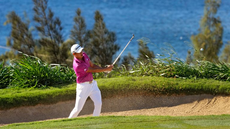 Collin Morikawa hits from the bunker on the 12th green during the second round of the Tournament of Champions golf event, Friday, Jan. 6, 2023, at Kapalua Plantation Course in Kapalua, Hawaii. (Matt York/AP)