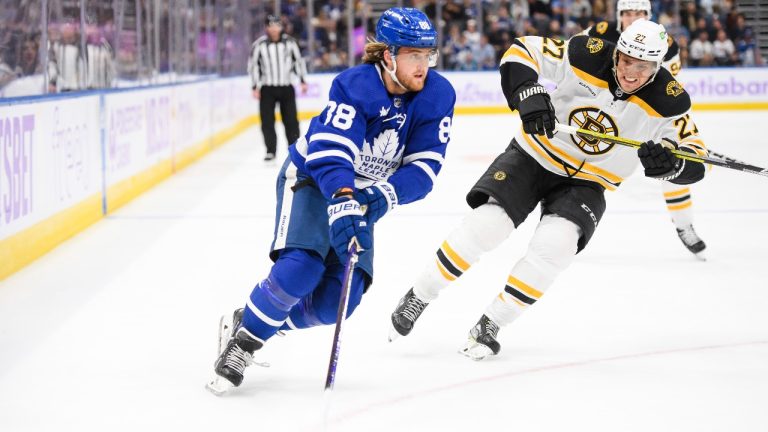 Toronto Maple Leafs forward William Nylander (88) moves the puck forward while defended by Boston Bruins defenceman Hampus Lindholm (27) during second period NHL hockey action, in Toronto on Saturday, Nov. 5, 2022. (Christopher Katsarov/CP)