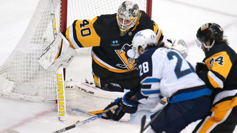 Winnipeg Jets center Kevin Stenlund (28) can't get off a shot in front of Pittsburgh Penguins goaltender Dustin Tokarski (40) during the first period of an NHL hockey game in Pittsburgh, Friday, Jan. 13, 2023. (Gene J. Puskar/AP)