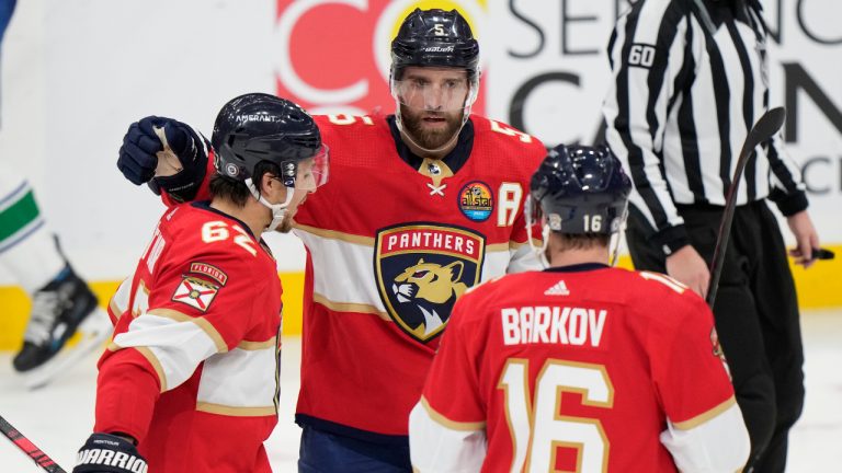 Florida Panthers defenseman Aaron Ekblad (5) celebrates after scoring with defenseman Brandon Montour (62) and center Aleksander Barkov (16) during the second period of an NHL hockey game against the Vancouver Canucks, Saturday, Jan. 14, 2023, in Sunrise, Fla. (Wilfredo Lee/AP)