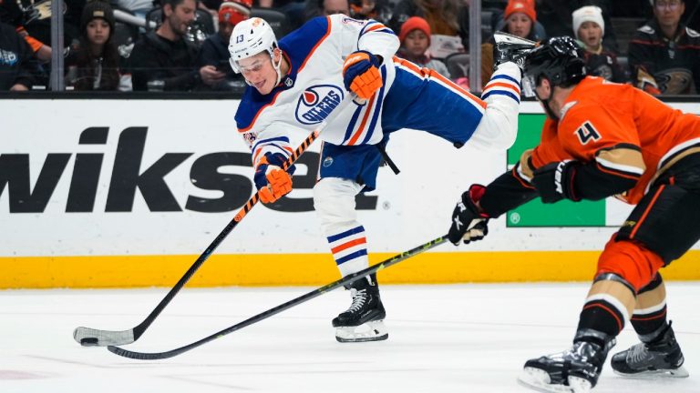 Edmonton Oilers' Jesse Puljujarvi (13) shoots as he is pressured by Anaheim Ducks' Cam Fowler (4) during the second period of an NHL hockey game Wednesday, Jan. 11, 2023, in Anaheim, Calif. (Jae C. Hong/AP)