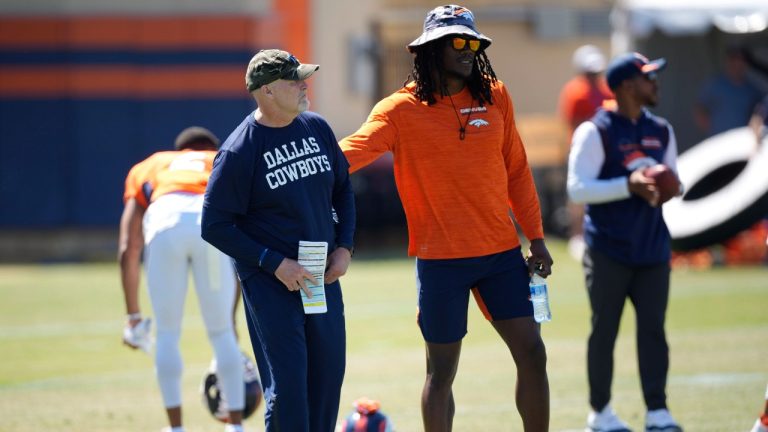 Denver Broncos linebacker Randy Gregory, right, greets Dallas Cowboys defensive coordinator Dan Quinn during NFL football practice Thursday, Aug. 11, 2022, in Centennial, Colo. (David Zalubowski/AP Photo)