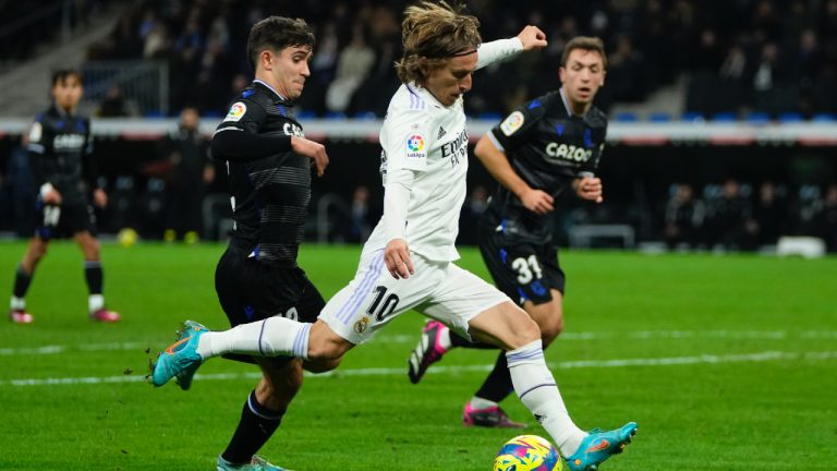 Real Madrid's Luka Modric, center, takes a shot on goal during the Spanish La Liga soccer match between Real Madrid and Real Sociedad, at the Santiago Bernabeu stadium in Madrid, Sunday, Jan. 29, 2023. (Manu Fernandez/AP)