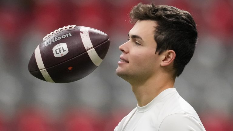 B.C. Lions quarterback Nathan Rourke tosses a football in the air before the CFL western semi-final football game against the Calgary Stampeders in Vancouver on Sunday, November 6, 2022. (Darryl Dyck/The Canadian Press)