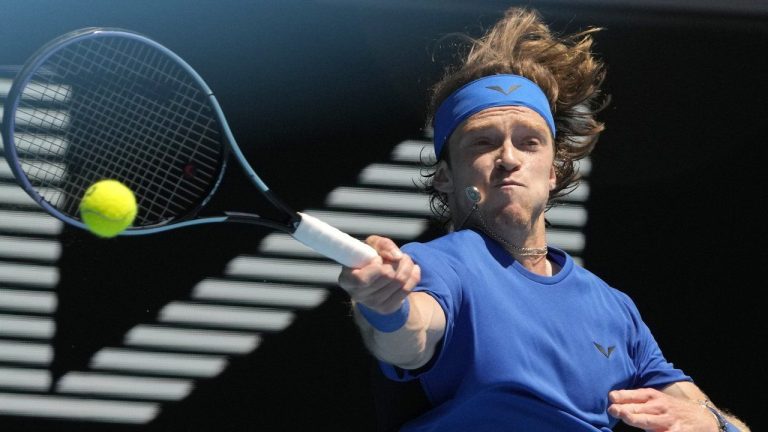 Andrey Rublev of Russia plays a forehand return to Daniel Evans of Britain during their third round match at the Australian Open tennis championship in Melbourne, Australia, Saturday, Jan. 21, 2023. (Ng Han Guan/AP)