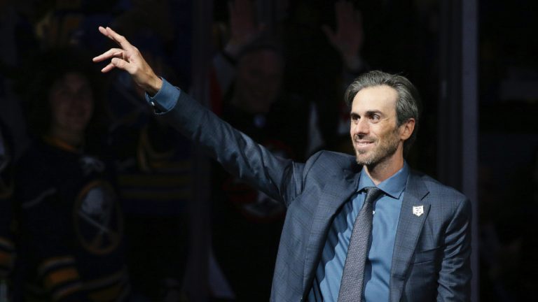 Former Buffalo Sabres goaltender Ryan Miller waves to the crowd as he's introduced before the team's NHL hockey game against the New York Islanders on Thursday, Jan. 19, 2023, in Buffalo, N.Y. (Joshua Bessex/AP)