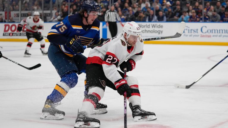 Ottawa Senators' Dylan Gambrell (27) handles the puck as St. Louis Blues' Tyler Tucker (75) defends during the first period of an NHL hockey game Monday, Jan. 16, 2023, in St. Louis. (Jeff Roberson/AP)