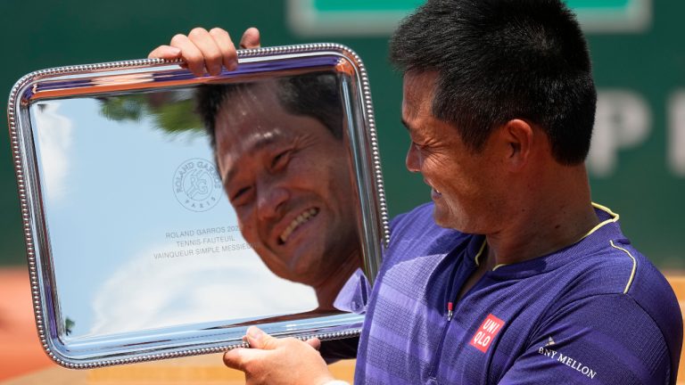 Japan's Shingo Kunieda holds the trophy after winning the men's wheelchair singles final match against Argentina's Gustavo Fernandez in three sets, 6-2, 5-7, 7-5, at the French Open tennis tournament in Roland Garros stadium in Paris, France, Saturday, June 4, 2022. (Michel Euler/AP)