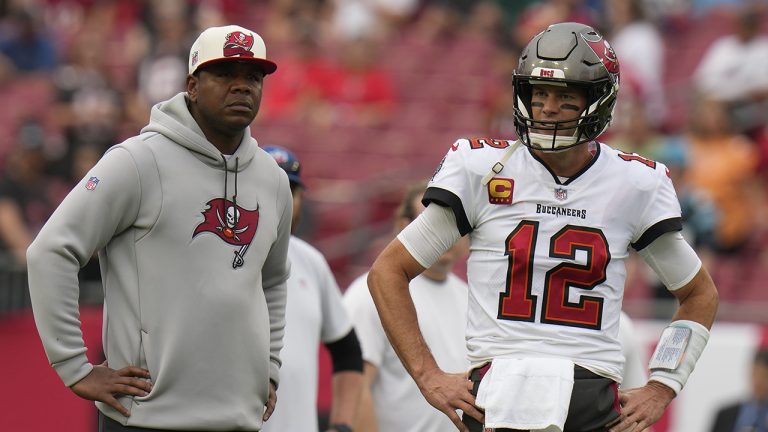 Tampa Bay Buccaneers quarterback Tom Brady and offensive coordinator Byron Leftwich watch before an NFL football game between the Carolina Panthers and the Tampa Bay Buccaneers on Sunday, Jan. 1, 2023, in Tampa, Fla. Byron Leftwich has been fired as offensive coordinator of the Tampa Bay Buccaneers, a person with knowledge of the dismissal told the Associated Press on Thursday, Jan. 19, 2023.(Chris O'Meara/AP)