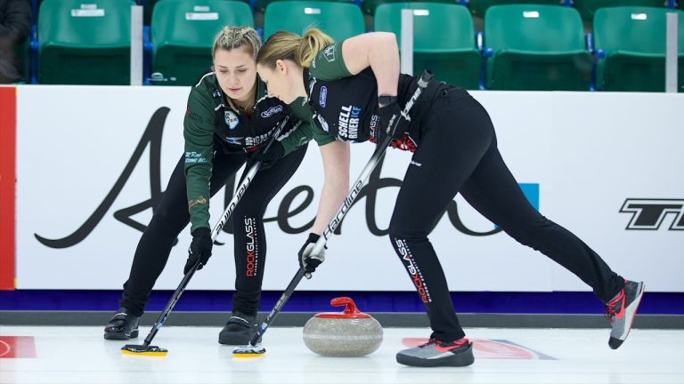 Abby Ackland (left) and Sara Oliver (right) sweep a stone during Draw 15 of the Co-op Canadian Open on Friday, Jan. 13, 2023, in Camrose, Alta. (Anil Mungal/GSOC)