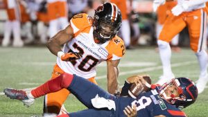 B.C. Lions Bo Lokombo (20) moves in on Montreal Alouettes quarterback Vernon Adams Jr. during second half CFL football action in Montreal, Saturday, September 18, 2021.  (Graham Hughes/CP)