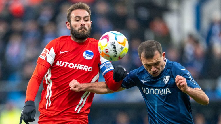 Berlin's Lucas Tousart, left, and Bochum's Kevin Stoeger challenge for the ball during the German Bundesliga soccer match between VfL Bochum and Hertha BSC Berlin in Bochum, Germany, Saturday, Jan. 21, 2023. (David Inderlied/dpa via AP) 