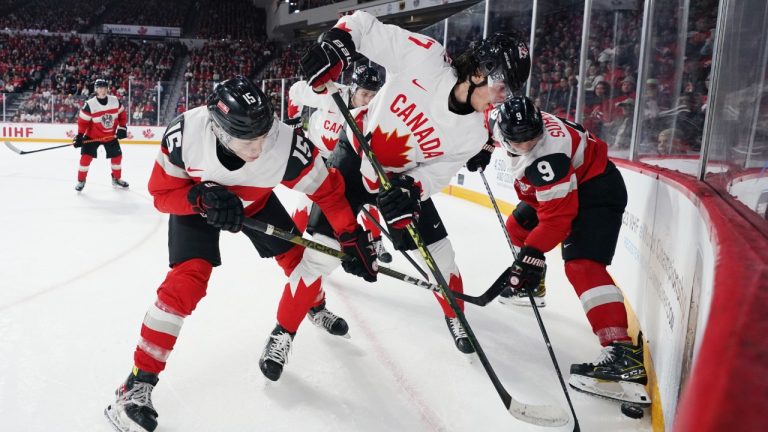 Canada’s Colton Dach, centre, battles for the puck in the corner with Austria’s Finn van Ee, left, and Aron Summer during second period IIHF World Junior Hockey Championship action in Halifax on Thursday, December 29, 2022. (Darren Calabrese/CP)