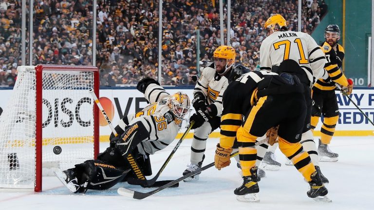 Pittsburgh Penguins goalie Tristan Jarry (35) deflects a shot in front of Boston Bruins' Jake DeBrusk (74) during the first period of the NHL Winter Classic hockey game, Monday, Jan. 2, 2023, at Fenway Park in Boston. (Michael Dwyer/AP)