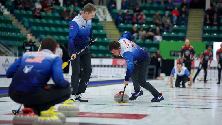 Korey Dropkin (centre) sweeps a stone for his team during Draw 8 of the Co-op Canadian Open on Wednesday, Jan. 11, 2023, in Camrose, Alta. (Anil Mungal/GSOC)