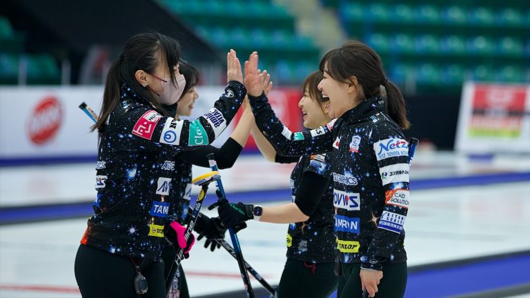 Satsuki Fujisawa (left) and Chinami Yoshida (right) high-five after winning their game on Wednesday, Jan. 11, 2023, at the Co-op Canadian Open in Camrose, Alta. (Anil Mungal/GSOC)