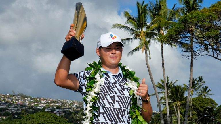 Si Woo Kim holds the champions trophy after the final round of the Sony Open golf tournament, Sunday, Jan. 15, 2023, at Waialae Country Club in Honolulu. (Matt York/AP) 