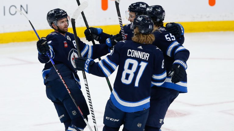 Winnipeg Jets' Josh Morrissey (44), Neal Pionk (4), Kyle Connor (81) and Mark Scheifele (55) celebrate Scheifele’s goal against the Vancouver Canucks during second period NHL action in Winnipeg, Thursday, December 29, 2022. (John Woods/CP)