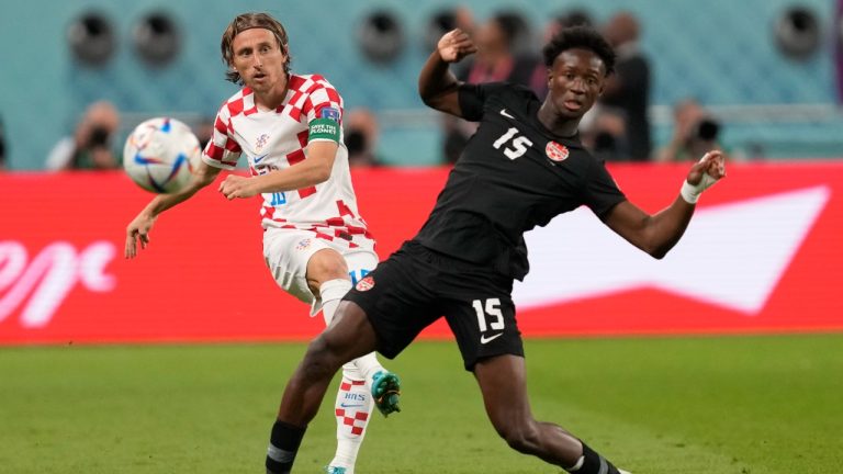 Croatia's Luka Modric, left, pass the ball past Canada's Ismael Kone during the World Cup group F soccer match between Croatia and Canada, at the Khalifa International Stadium in Doha, Qatar, Sunday, Nov. 27, 2022. (Darko Vojinovic/AP)