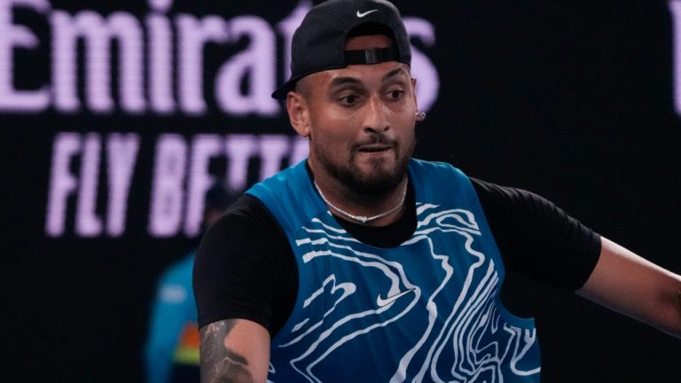 Australia's Nick Kyrgios plays a forehand return to Serbia's Novak Djokovic during an exhibition match on Rod Laver Arena ahead of the Australian Open tennis championship in Melbourne, Australia, Friday, Jan. 13, 2023.