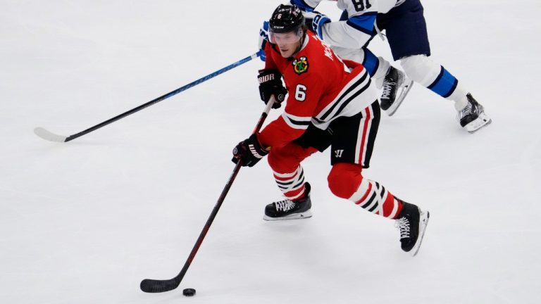 Chicago Blackhawks defenseman Jake McCabe (6) controls the puck in front of Winnipeg Jets left wing Kyle Connor during the first period of an NHL hockey game in Chicago, Friday, Dec. 9, 2022. (Nam Y. Huh/AP)