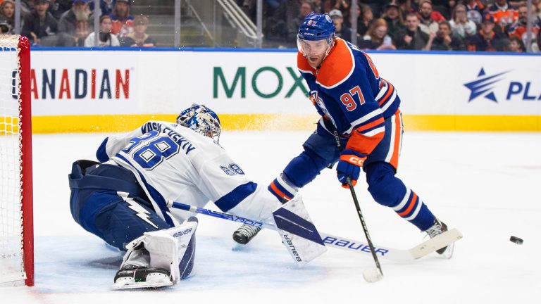 Tampa Bay Lightning goalie Andrei Vasilevskiy (88) poke checks Edmonton Oilers' Connor McDavid (97) during second period NHL action in Edmonton. (Jason Franson/CP)