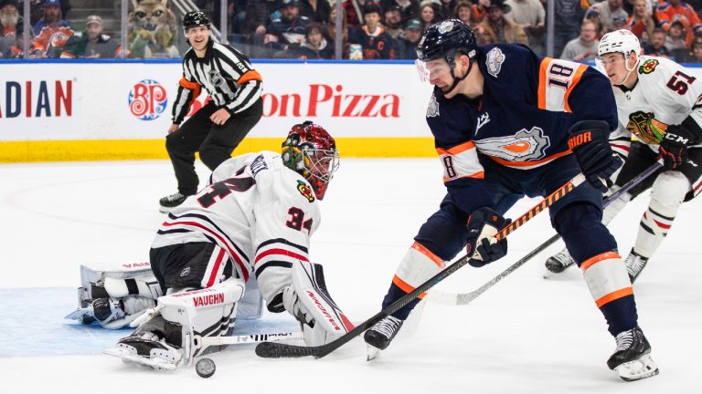 Chicago Blackhawks' goalie Petr Mrazek (34) makes a save on Edmonton Oilers' Zach Hyman (18) during second period NHL action in Edmonton on Saturday January 28, 2023.(Jason Franson/CP)