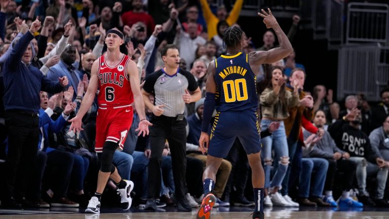 Indiana Pacers guard Bennedict Mathurin (00) celebrates his three-point basket as Chicago Bulls guard Alex Caruso (6) reacts during the second half of an NBA basketball game in Indianapolis, Tuesday, Jan. 24, 2023. The Pacers defeated the Bulls 116-110. (Michael Conroy/AP Photo)