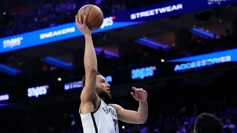 Brooklyn Nets' Ben Simmons, left, goes up for a shot against Philadelphia 76ers' Joel Embiid during the first half of an NBA basketball game, Wednesday, Jan. 25, 2023, in Philadelphia.