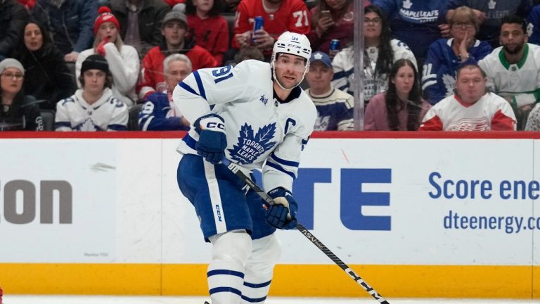 Toronto Maple Leafs center John Tavares (91) passes as Detroit Red Wings defenseman Moritz Seider (53) tries to block in the third period of an NHL hockey game Thursday, Jan. 12, 2023, in Detroit.