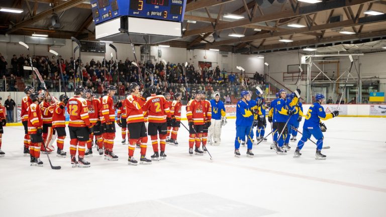 Members of the University of Calgary Dinos men's hockey team and Ukrainian U25 National Team salute the crowd Monday, Jan. 2, 2022, at Father David Bauer Arena in Calgary. (Chris Lindsey/University of Calgary)