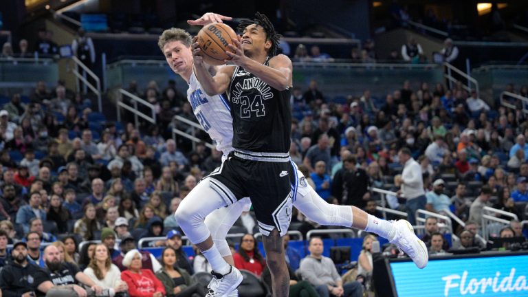 San Antonio Spurs guard Devin Vassell (24) goes to the basket as Orlando Magic center Moritz Wagner (21) defends during the first half of an NBA basketball game Friday, Dec. 23, 2022, in Orlando, Fla. (Phelan M. Ebenhack/AP)