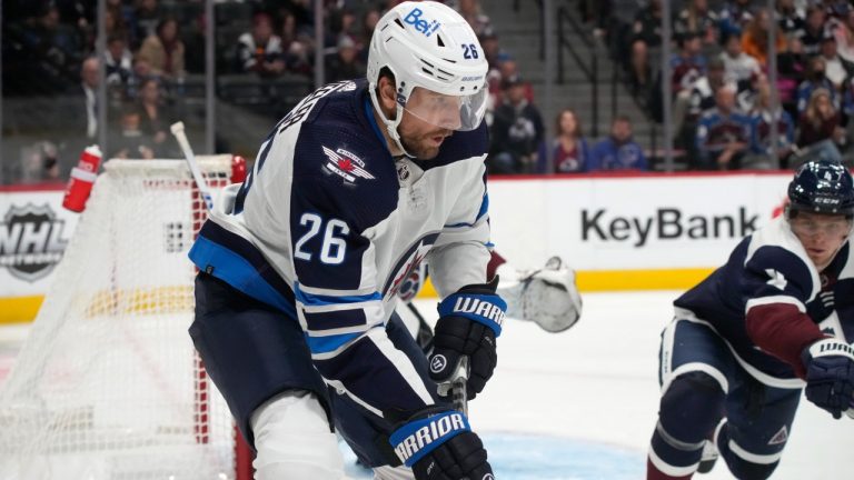 Winnipeg Jets right wing Blake Wheeler, front, looks to pass the puck away from Colorado Avalanche defenseman Bowen Byram during the second period of an NHL hockey game Wednesday, Oct. 19, 2022, in Denver. (David Zalubowski/AP)