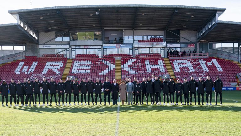 Britain's King Charles III and Camilla, the Queen Consort meet Wrexham Soccer team co owners, US actors Ryan Reynolds and Rob McElhenney and players during their visit to Wrexham Association Football Club's Racecourse Ground, in Wrexham, England, Friday, Dec. 9, 2022.   (Arthur Edwards/Pool Photo via AP)