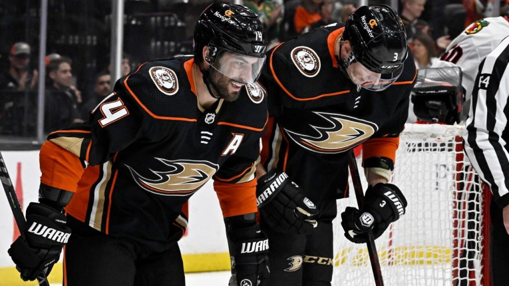 Edmonton Oilers' William Lagesson (84) checks Winnipeg Jets