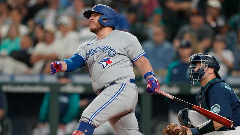 Blue Jays Encarnacion and Bautista warm up under red sky while the