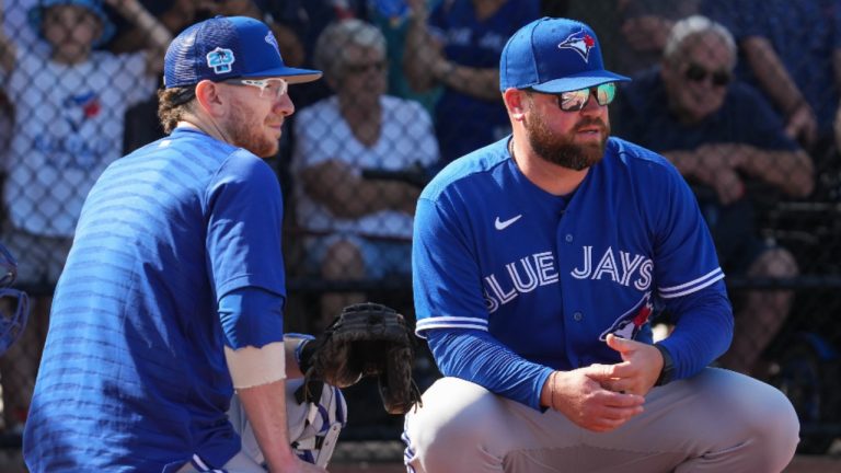 Toronto Blue Jays catcher Danny Jansen, left, talks with manager John Schneider during baseball spring training in Dunedin, Fla., on Tuesday, February 21, 2023. (Nathan Denette/CP)