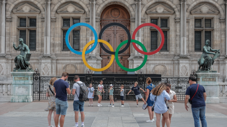 People gather at the Olympic rings at the City Hall in Paris, Monday, July 25, 2022. (AP)