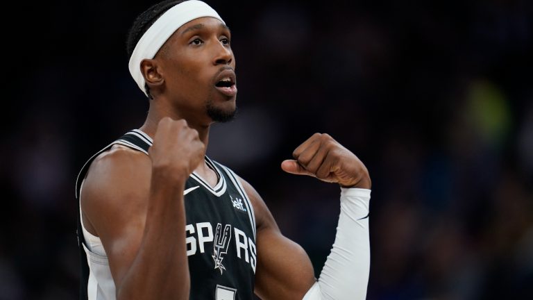 San Antonio Spurs guard Josh Richardson (7) celebrates after a Spurs basket during the second half of an NBA basketball game against the Minnesota Timberwolves, Monday, Oct. 24, 2022, in Minneapolis. (AP Photo/Abbie Parr)