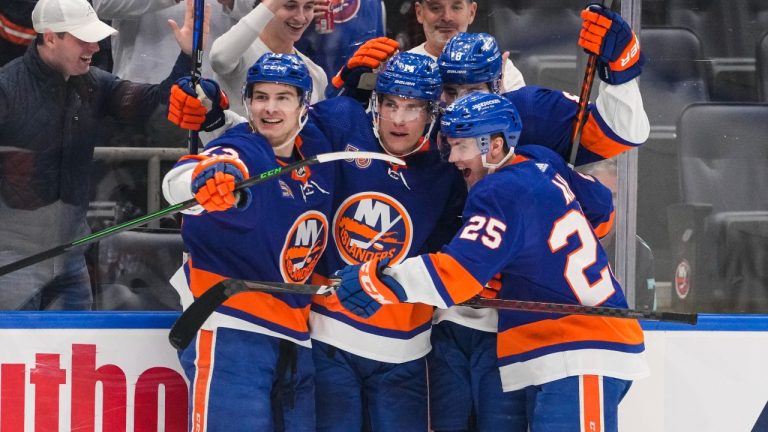 New York Islanders centre Bo Horvat (14) celebrates with teammates Sebastian Aho (25) and Mathew Barzal (13) after scoring a goal during the second period of an NHL hockey game against the Seattle Kraken. (Frank Franklin II/AP)