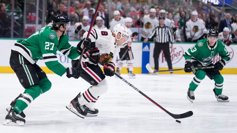 Chicago Blackhawks defenseman Jack Johnson (8) attempts to clear the puck under pressure from Dallas Stars' Mason Marchment (27) and Wyatt Johnston (53) in the first period of an NHL hockey game, Wednesday, Feb. 22, 2023, in Dallas. (Tony Gutierrez/AP)