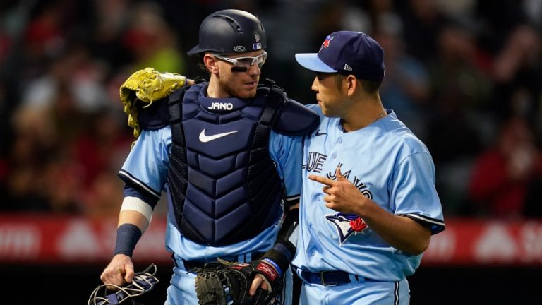 Toronto Blue Jays catcher Danny Jansen, left, talks with starting pitcher Yusei Kikuchi as they return to the dugout after the second inning of a baseball game against the Los Angeles Angels. (Ashley Landis/AP)