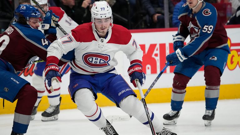 Montreal Canadiens center Kirby Dach, center, drives between Colorado Avalanche defenseman Samuel Girard, left, and center Ben Meyers in the second period of an NHL hockey game Wednesday, Dec. 21, 2022, in Denver. (David Zalubowski/AP)