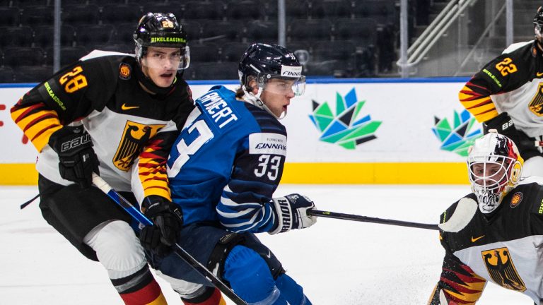 Finland's Brad Lambert (33) is stopped by Germany's goalie Florian Bugl (29) as Adrian Klein (28) defends during first period IIHF World Junior Hockey Championship quarterfinal action in Edmonton on Wednesday August 17, 2022. (Jason Franson/CP)