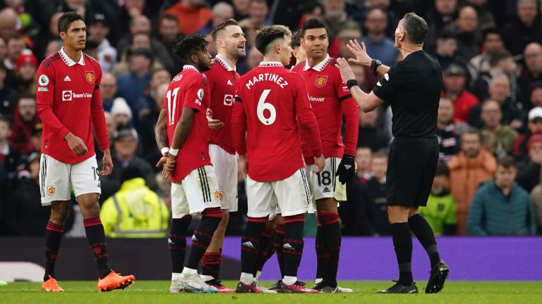 Referee Andre Marriner, right, discusses with Manchester United players during the English Premier League soccer match between Manchester United and Crystal Palace, at the Old Trafford stadium in Manchester, England, Saturday, Feb. 4, 2023. (Dave Thompson/AP)