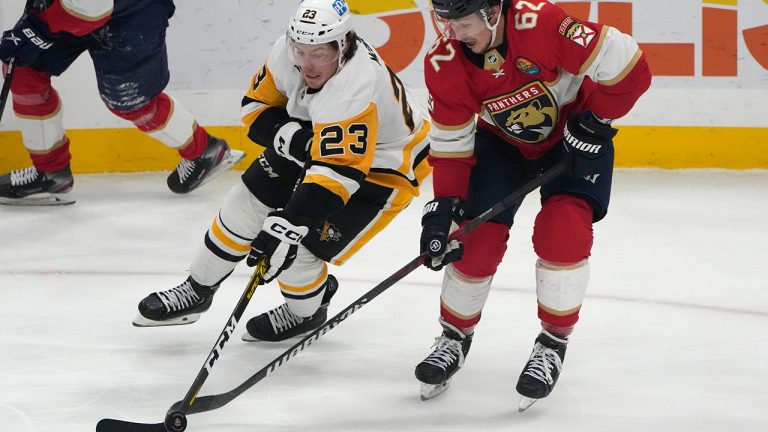 Pittsburgh Penguins left wing Brock McGinn skates with the puck as Florida Panthers defenseman Brandon Montour during the third period of an NHL hockey game, Thursday, Dec. 15, 2022, in Sunrise, Fla. (Lynne Sladky/AP)