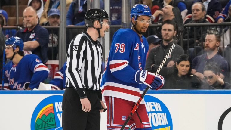 Linesman Kilian McNamara (93) escorts New York Rangers' K'Andre Miller (79) off the ice after Miller received a penalty during the first period of an NHL hockey game against the Los Angeles Kings, Sunday, Feb. 26, 2023, in New York. (Frank Franklin II/AP)